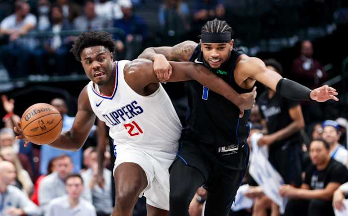 Nov 10, 2023; Dallas, Texas, USA; LA Clippers guard Kobe Brown (21) controls the ball as Dallas Mavericks guard Jaden Hardy (1) defends during the second half at American Airlines Center.